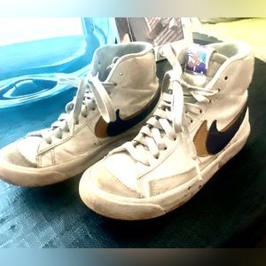 Size 3 white leather Nike high tops with blue/ gold swish detail.